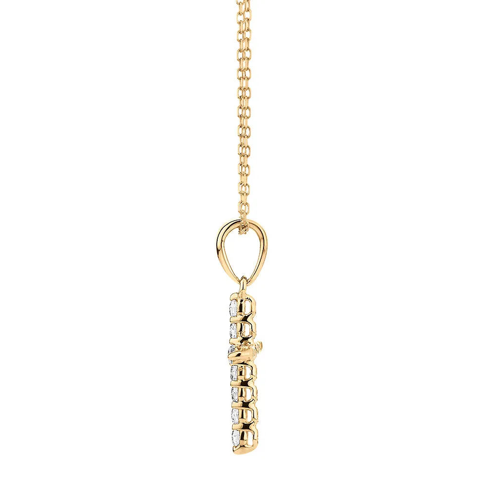 Cross pendant with diamond simulants in 10 carat yellow gold